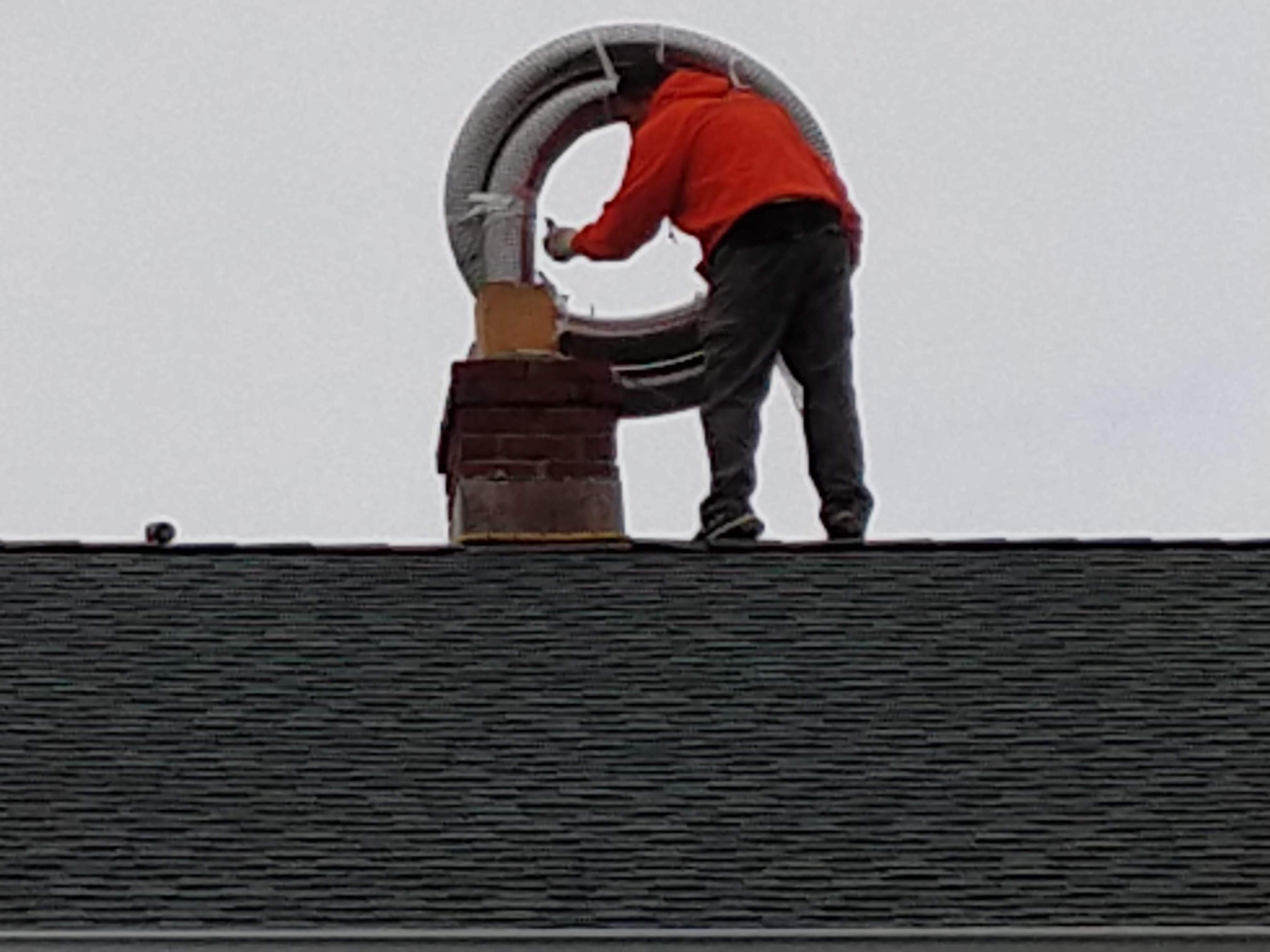 Flexible stainless chimney liner being installed in Rockville Centre, New York