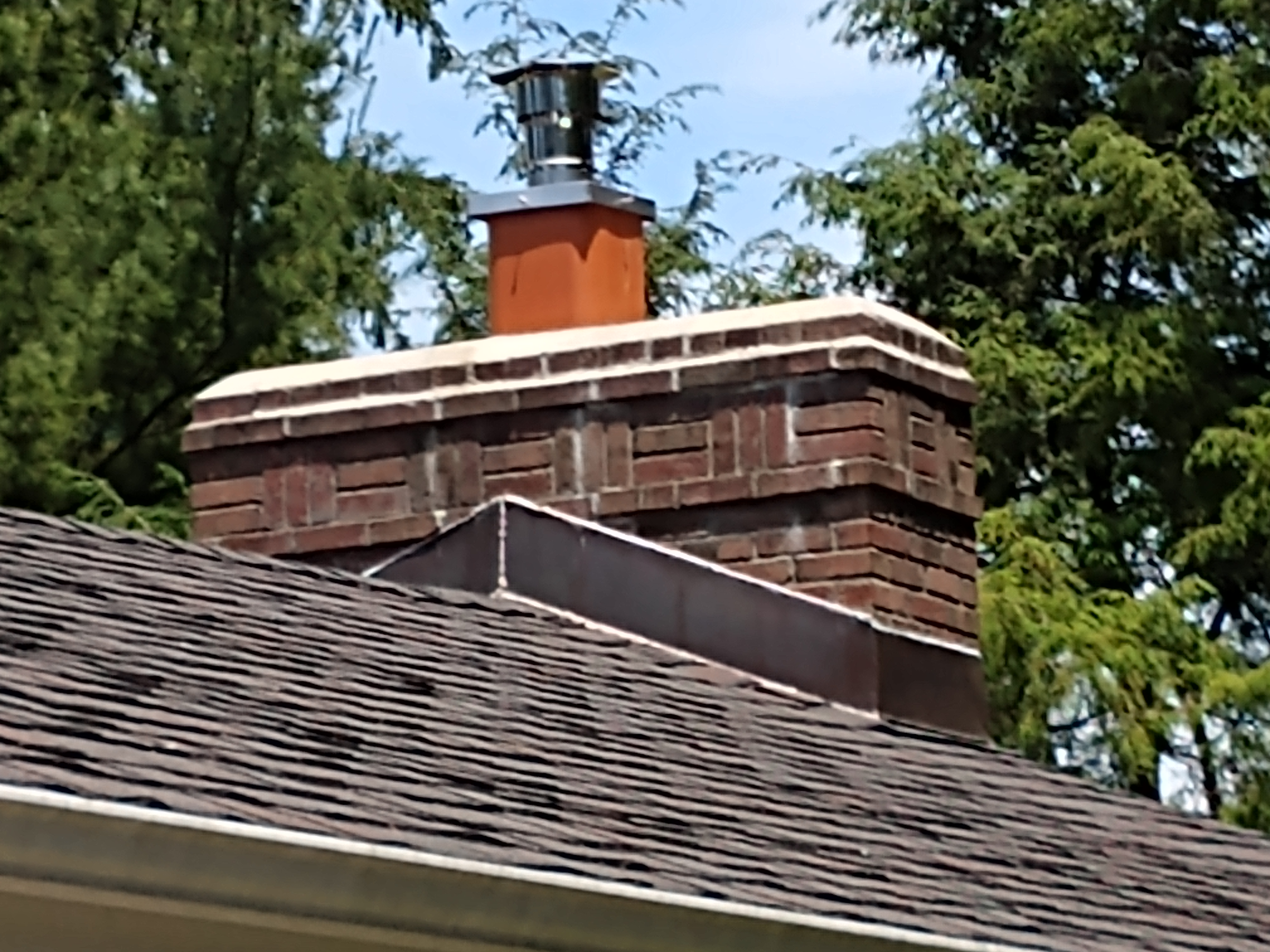 Stainless steel chimney cap with animal guard in Rockville Centre, New York